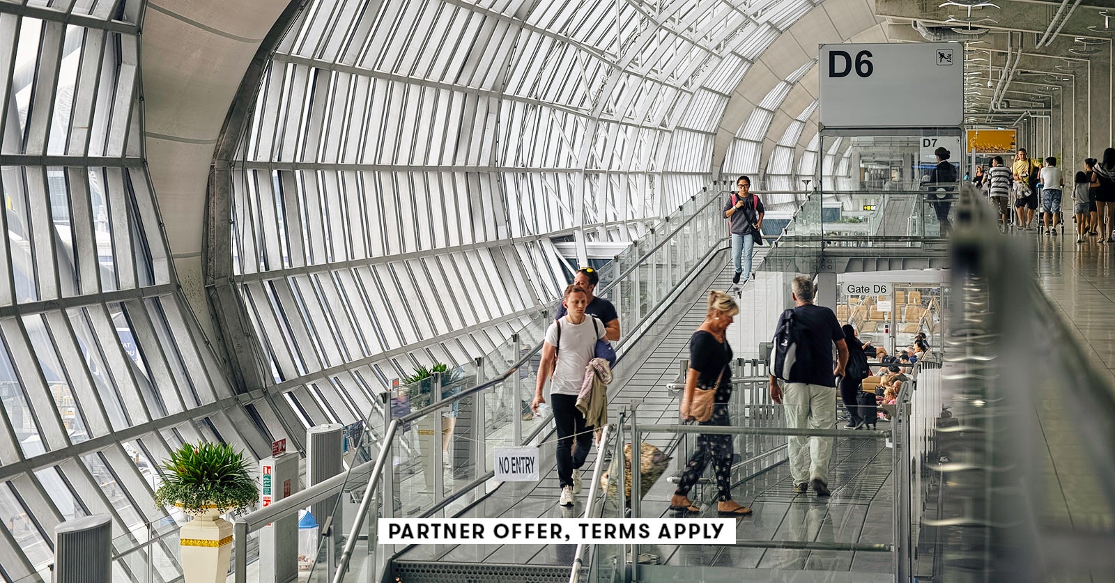 20250715 SOCIAL DISCLAIMER PARTER OFFER TERMS APPLY Passangers walking through deaprture gate at Suv