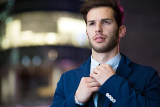 A man adjusting his ties in a suit Lexington County Careers In Government