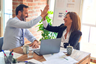 A man and woman laughing with success Harry Country Careers In Government