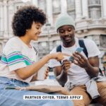 SOCIAL IMAGE PARTNER OFFER TERMS APPLY Friends on vacation using smartphone RgStudio 16