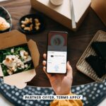 SOCIAL IMAGE PARTNER OFFER TERMS APPLY womans hand holding smartphone with takeaway food ordering mo