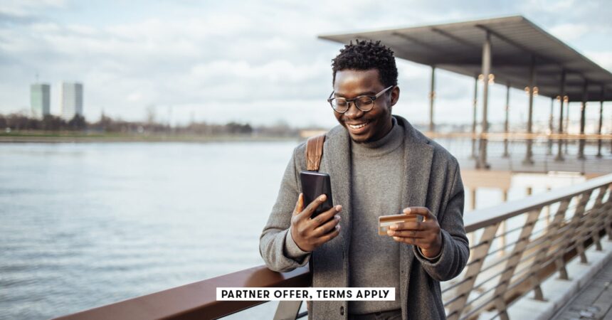SOCIAL IMAGE PARTNER OFFERS TERMS APPLY businessman standing on street and using smart phone and ban