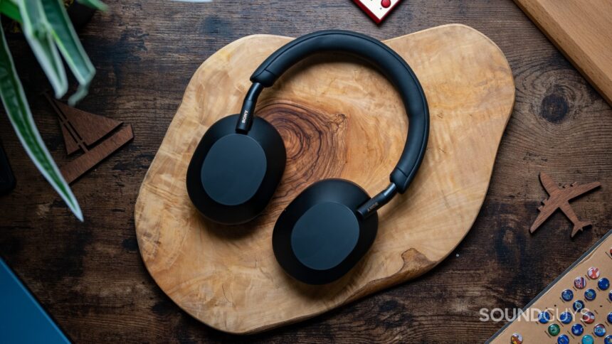 Sony WH 1000XM5 headphones laying flat on wooden table