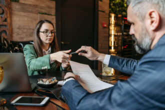 Woman taking pen for signing a paper Careers In Government