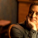 alan tudyk with his chin in his hand in resident alien