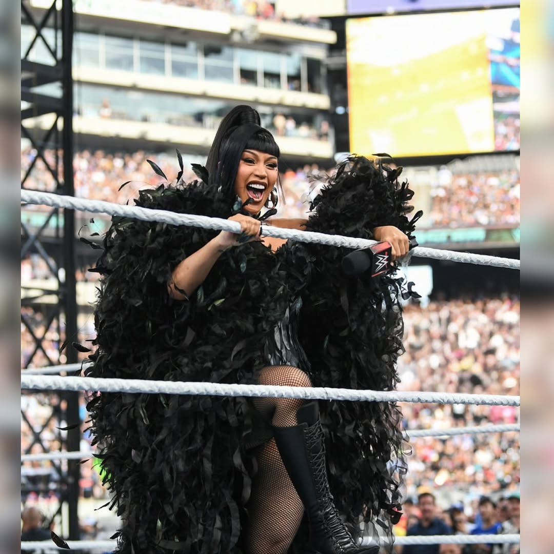 Cardi B Stuns in Custom Black Feather Corset Dramatic Cape and Le Silla Boots for WWE Performance of