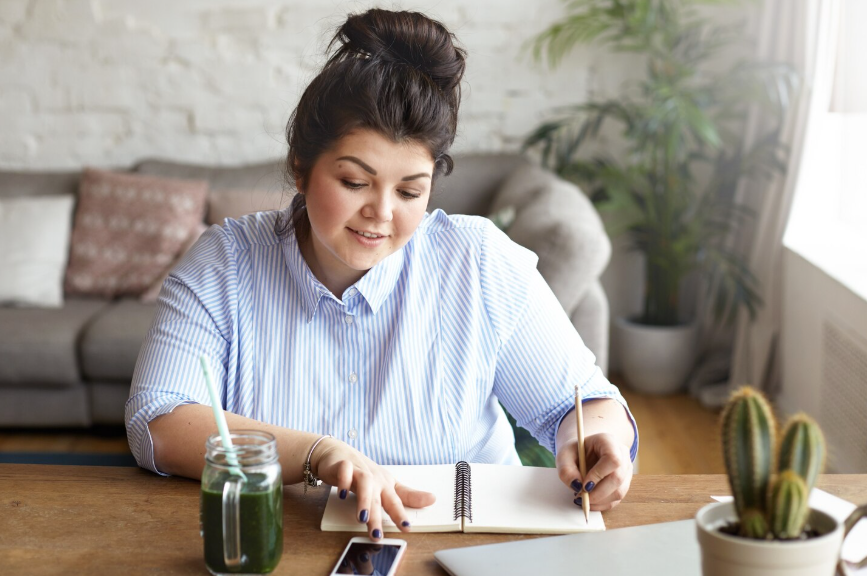 woman writing on a desk