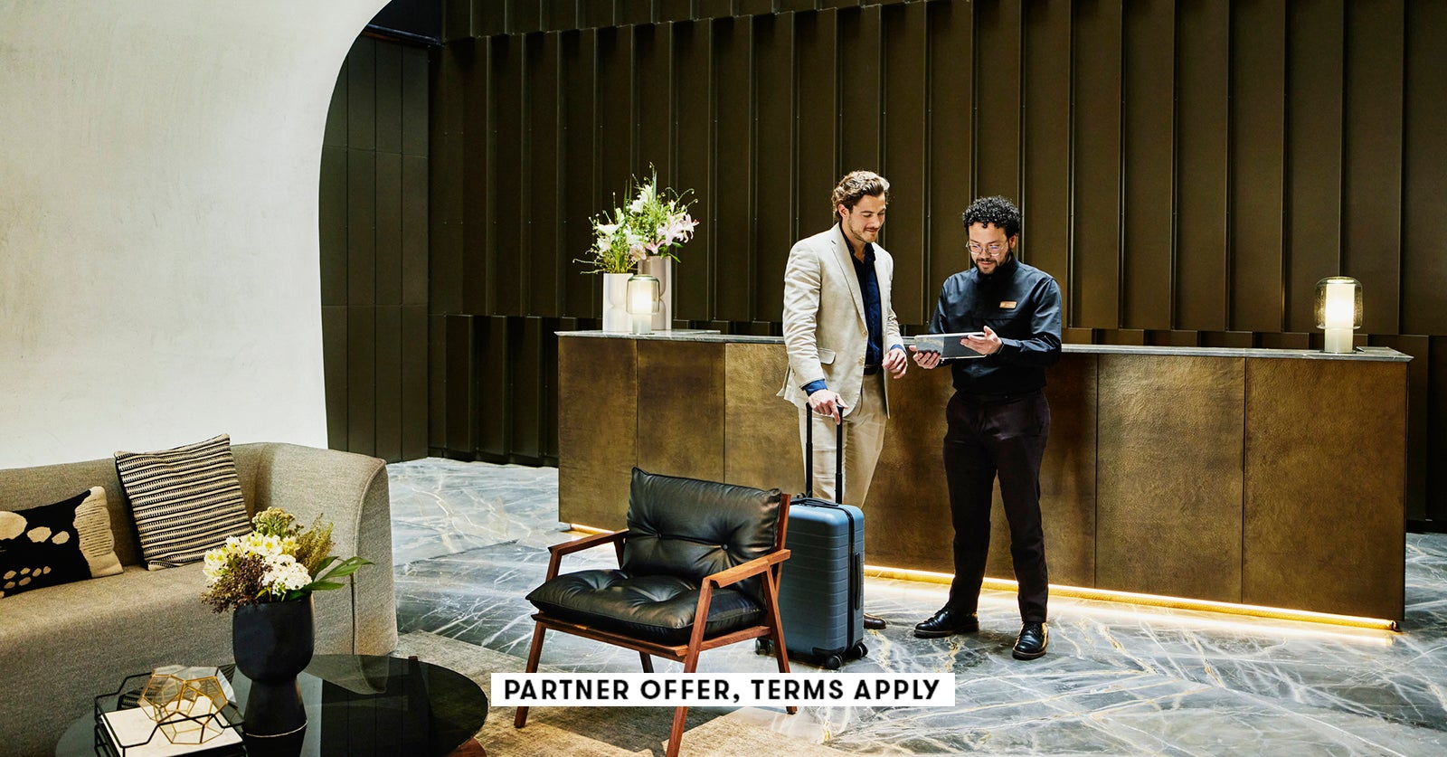 20250715 SOCIAL DISCLAIMER PARTER OFFER TERMS APPLY HOTEL MANAGER CHECKING IN BUSINESSMAN INTO HOTEL