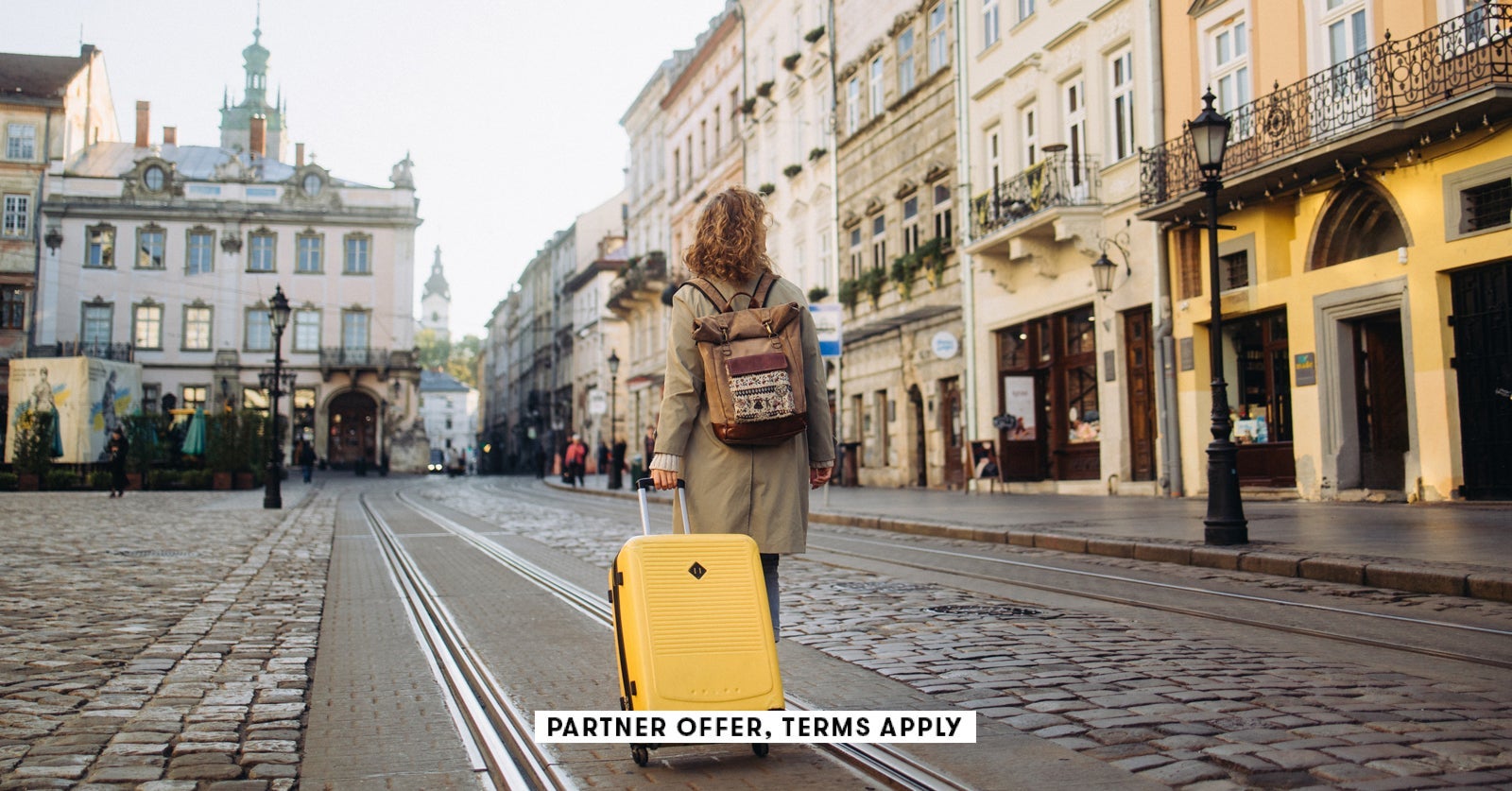 SOCIAL IMAGE PARTNER OFFER TERMS APPLY woman with a suitcase walking on European street Nazar Rybak