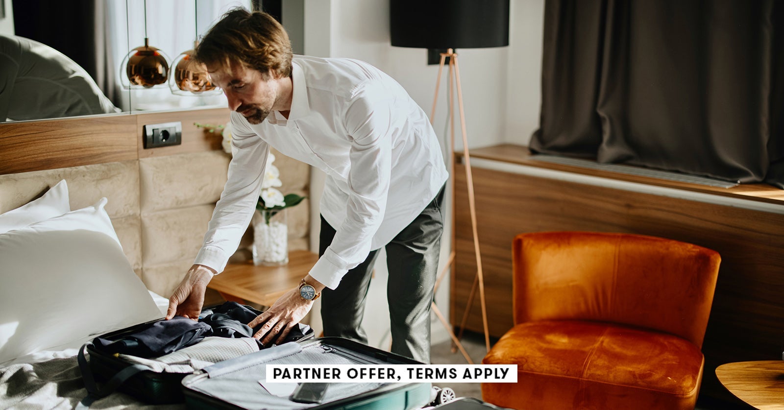 SOCIAL IMAGE PARTNER OFFER TERMS APPLY Business traveler packing up suitcase in hotel Anchiy SOCIAL