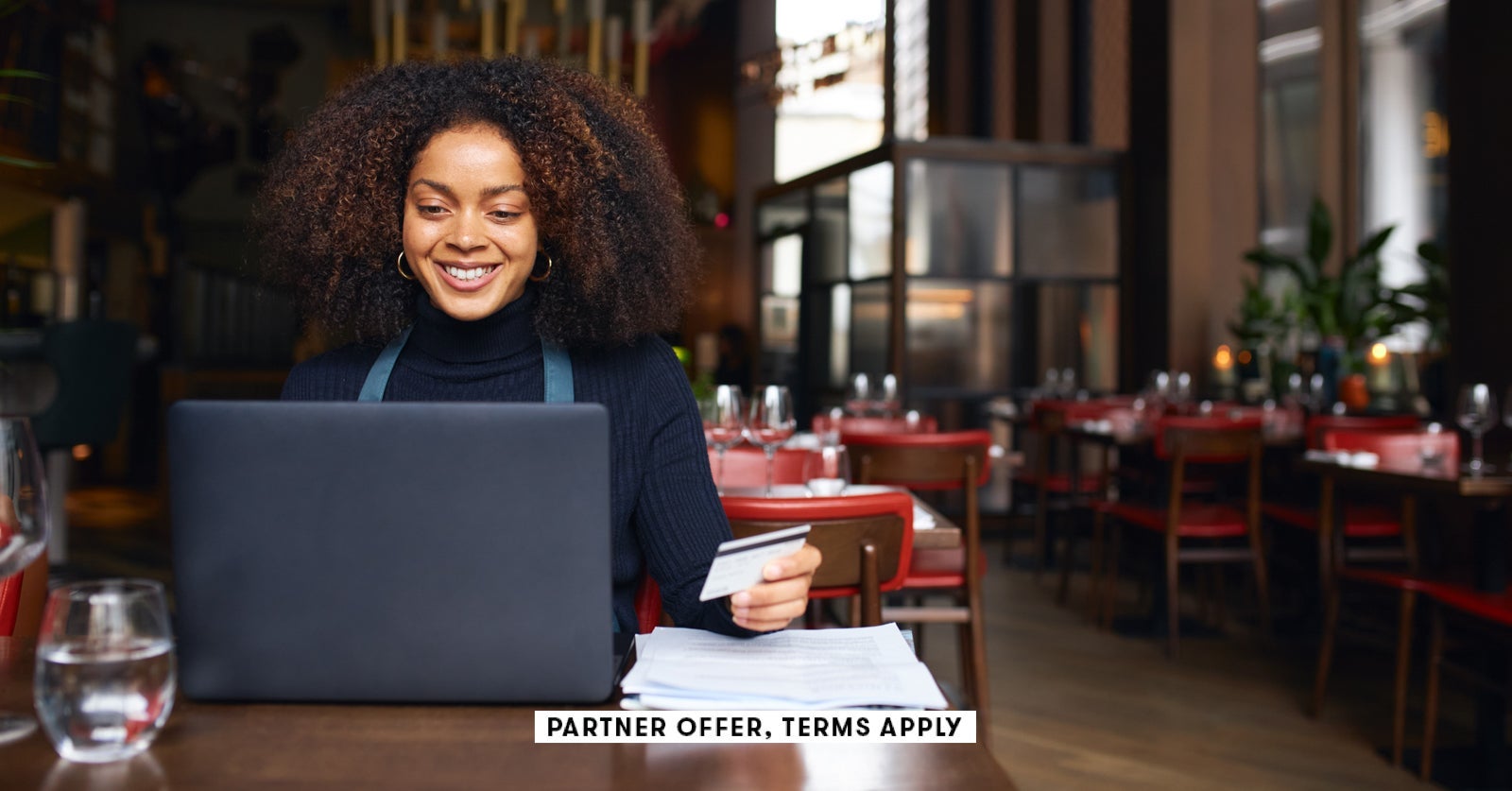 SOCIAL IMAGE PARTNER OFFERS TERMS APPLY restaurant owner using laptop and holding credit card SouthW
