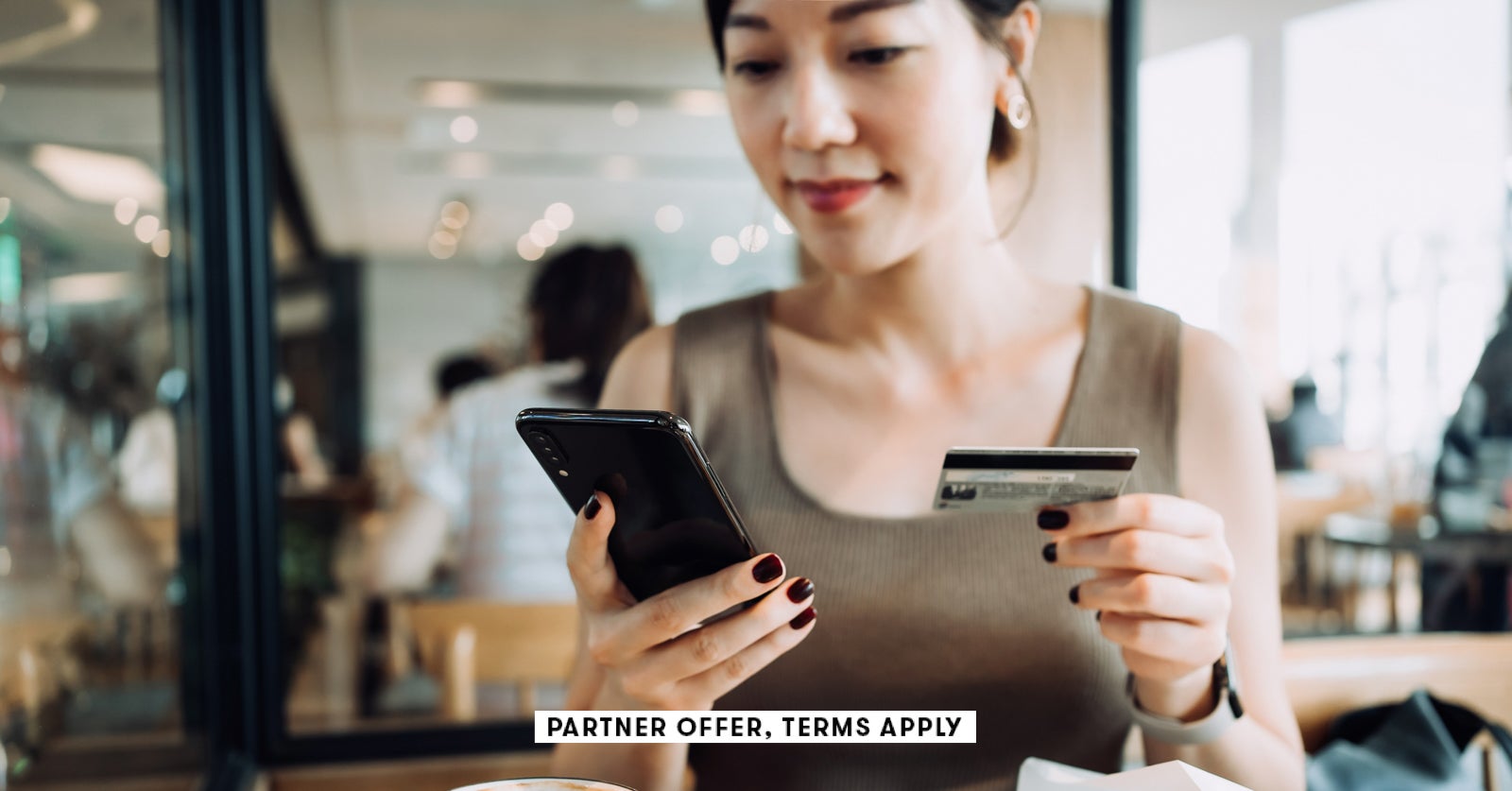 SOCIAL IMAGE PARTNER OFFERS TERMS APPLY woman managing online banking with smartphone and making mob