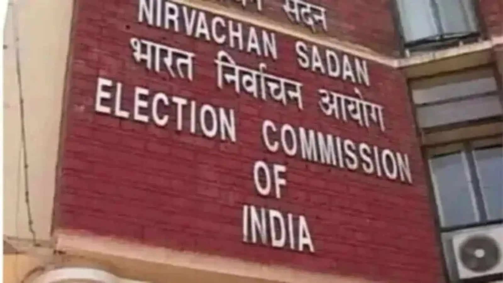 The image shows the official sign of the Election Commission of India on a brick wall indicating the