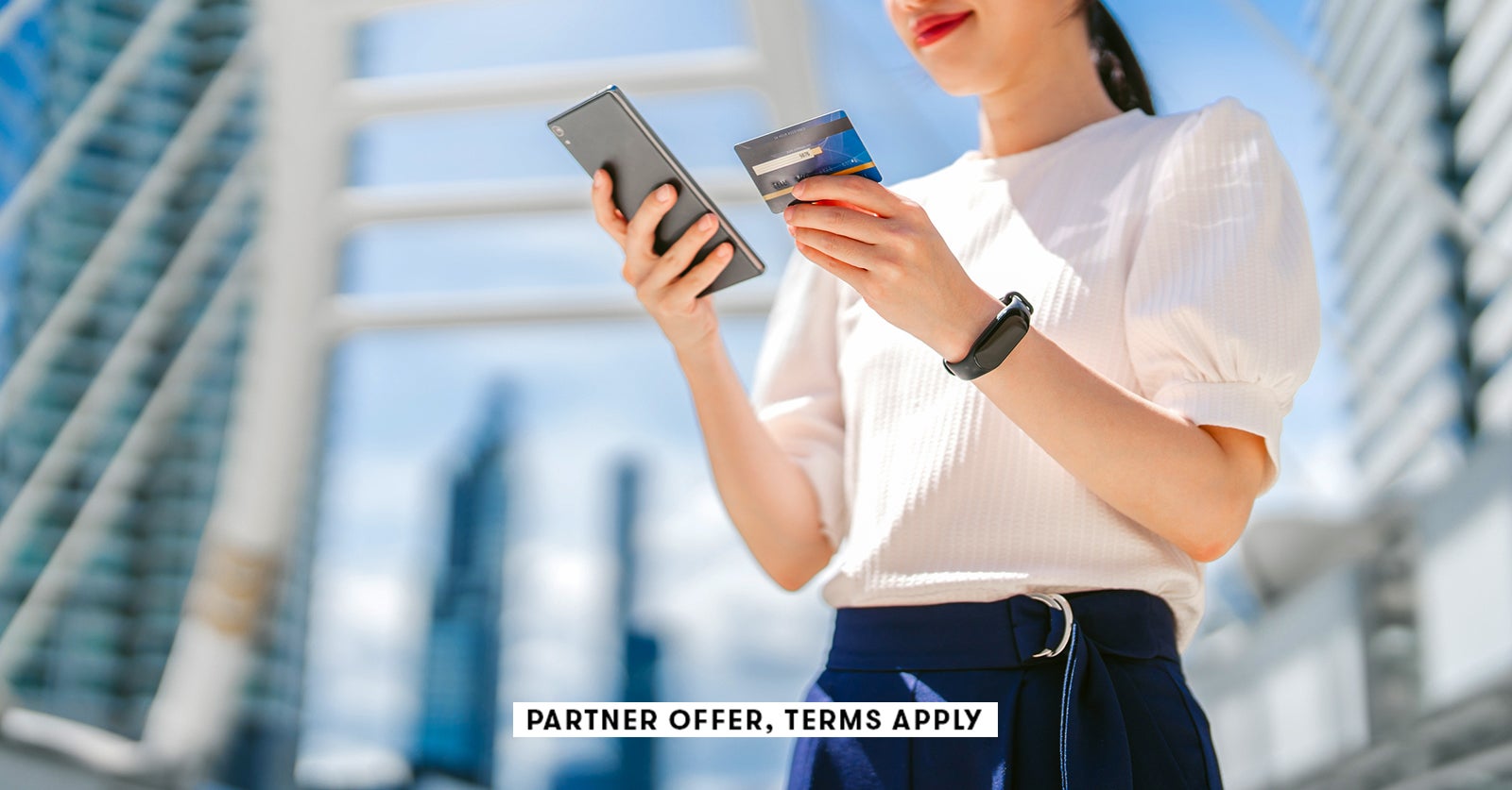 20250715 SOCIAL DISCLAIMER PARTER OFFER TERMS APPLY Person using credit card while on smart phone Wi