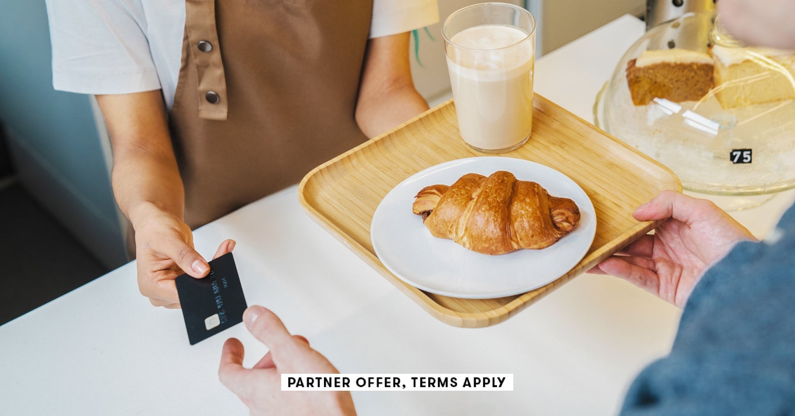 SOCIAL IMAGE PARTNER OFFER TERMS APPLY customer paying for his order with a credit card in a cafe I