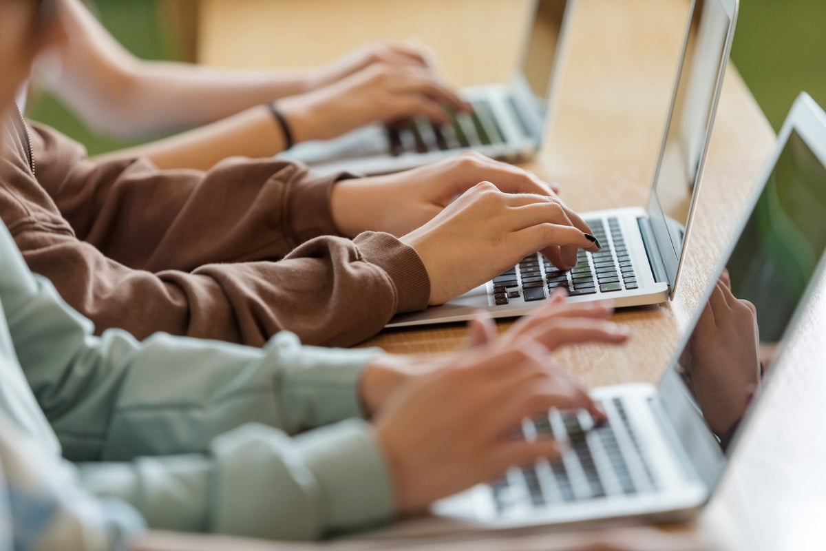 Teens typing on laptops