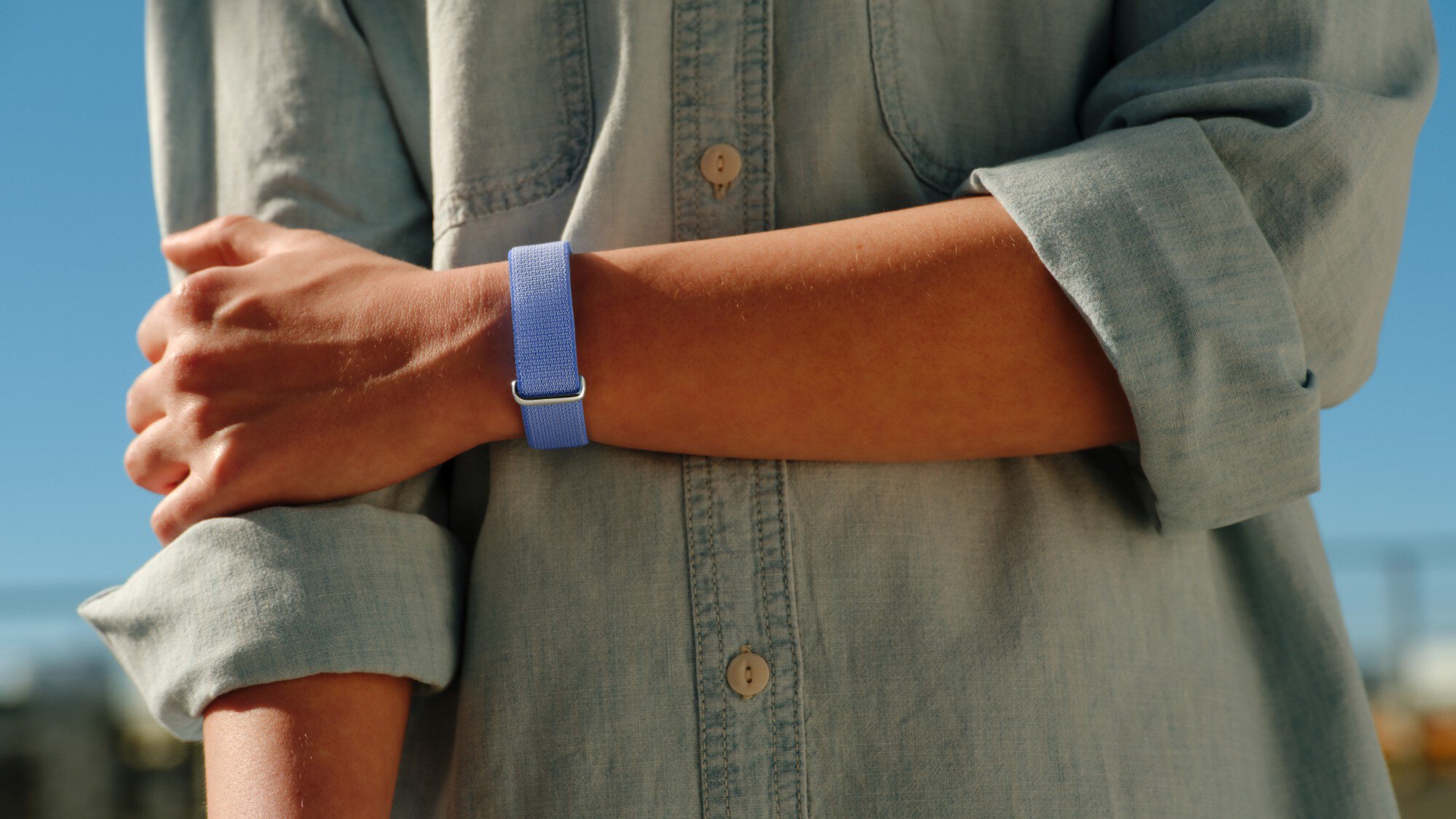 a person wearing the fitbit air on their wrist